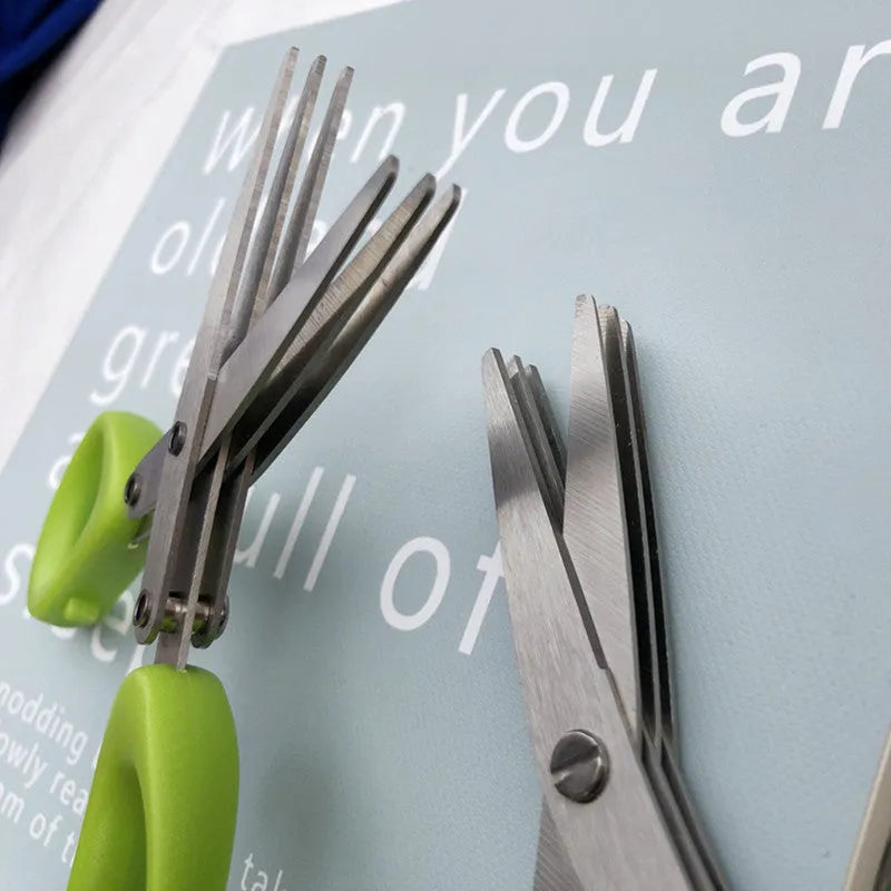 Green stainless steel multi-blade herb scissors with V-shaped design for cutting nori and green onions.