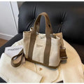 Beige soft canvas bucket-shaped messenger bag with sandwich pockets and three shoulder straps