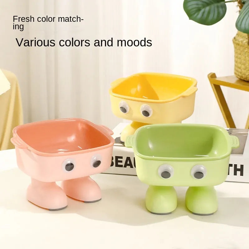 Green robot-shaped elevated cat bowl with tilted design and removable inner bowl on anti-slip base