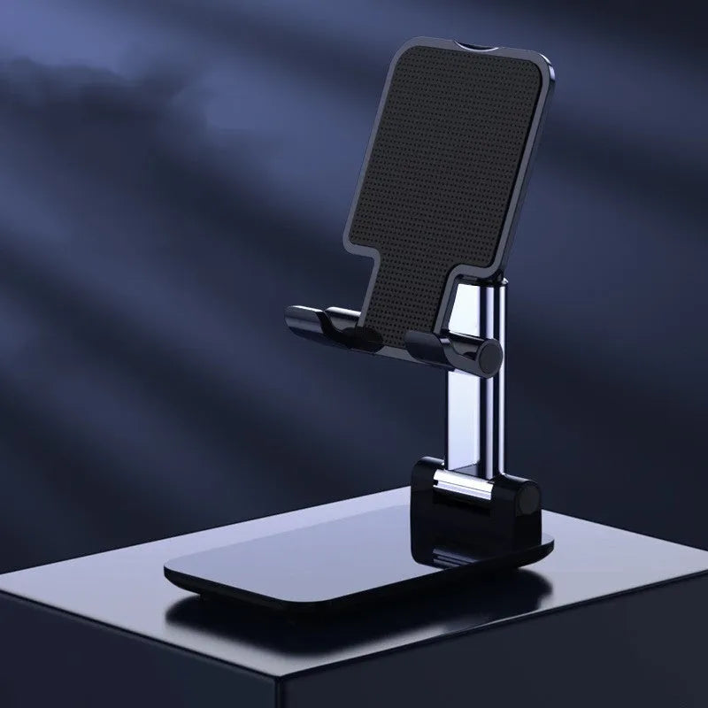 White folding telescopic mobile phone bracket holding a smartphone on a desktop.