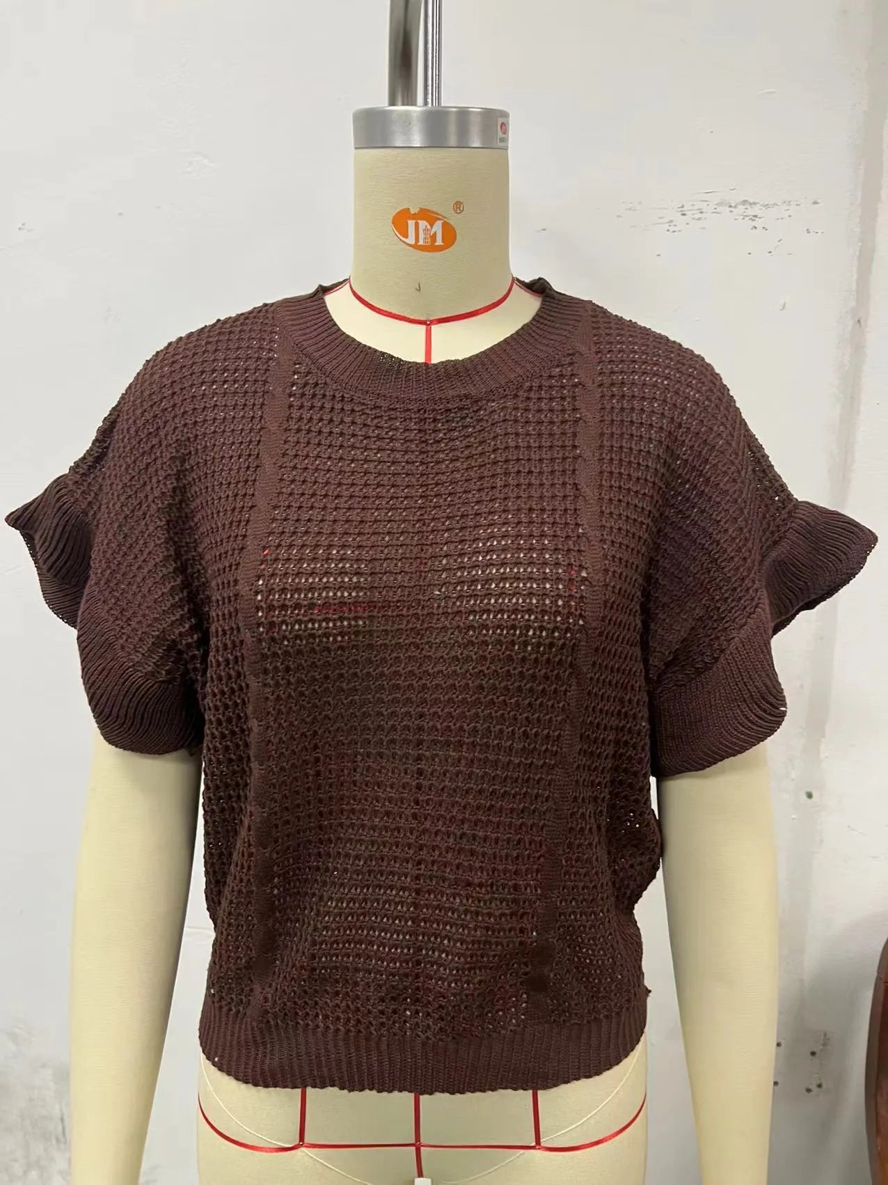 Twisted string design knitted pullover sweater with ruffled short sleeves in loose fit.