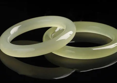 Solid ice silk jade round bar bracelet showing smooth geometric shape on a plain background