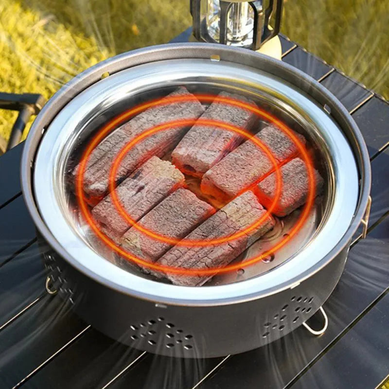 Portable stainless steel campfire grill with detachable parts and storage bag on grass