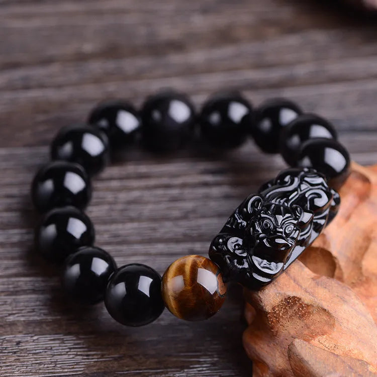 Natural obsidian Pi Xiu bracelet with carved charm, 12mm beads, on a gift box