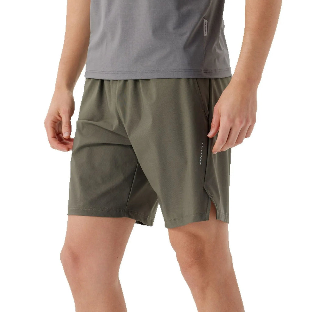 Man wearing grey ice silk nylon sports shorts with a mid-rise waistband.