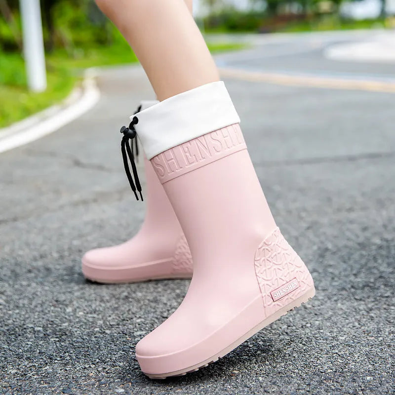 Women's solid colour PVC rain boots with non-slip soles in apricot, black, brown, or pink waterproof mouth options