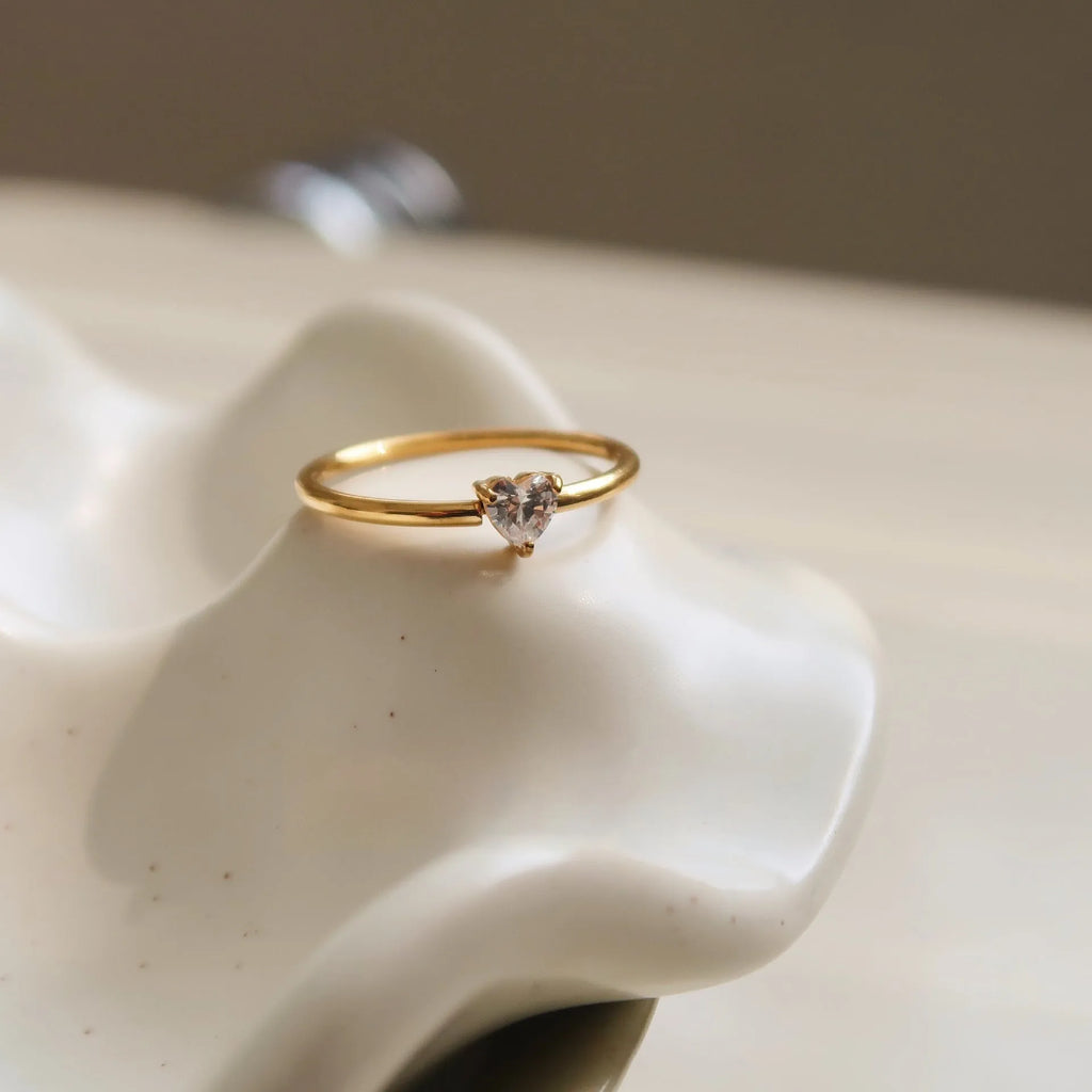 Golden electroplated stainless steel ring with love heart design, shown in sizes 5 to 8.