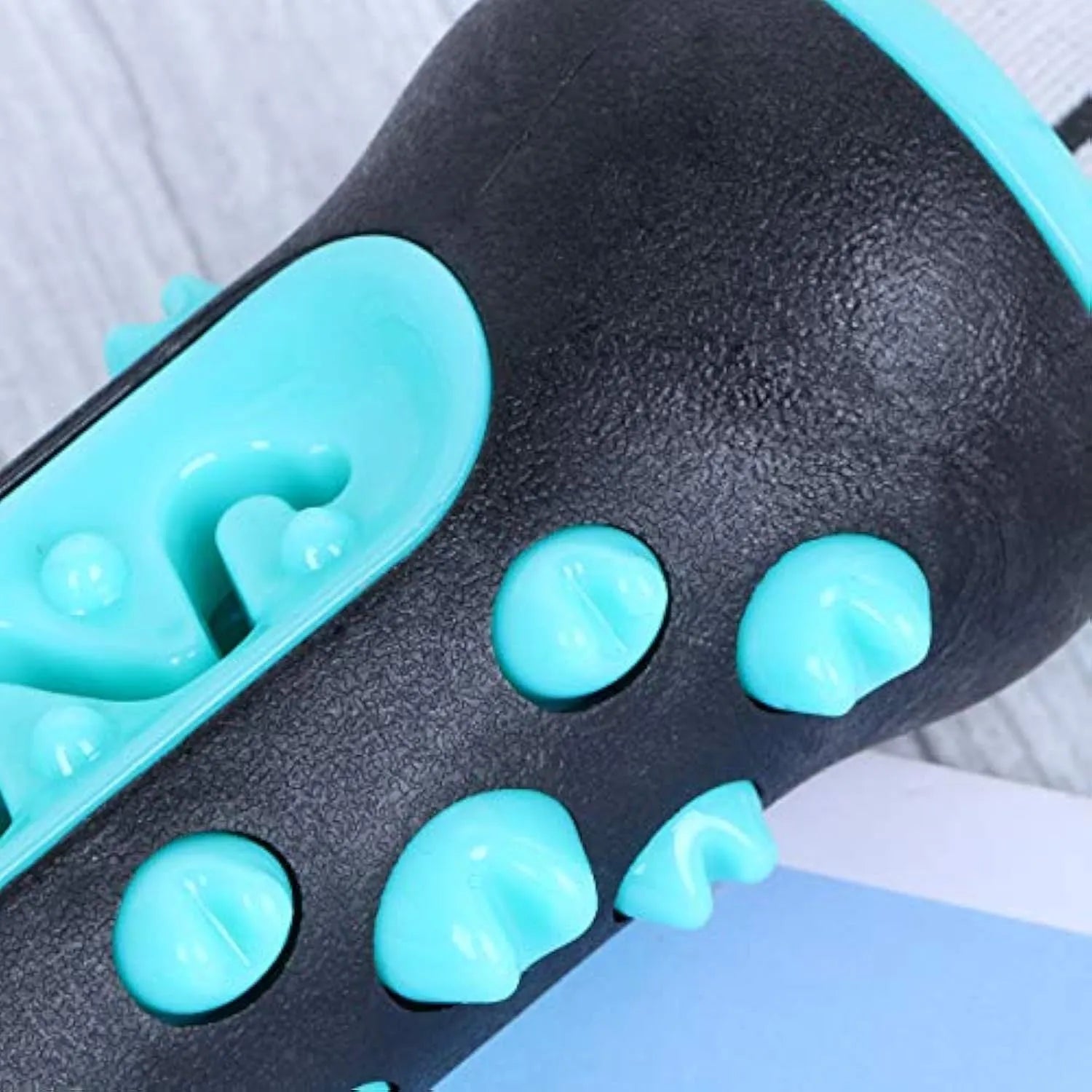 Natural rubber dog toothbrush chew toy in blue, showing textured surface for dental cleaning.