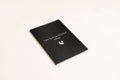 Black Dream Journal notebook with a business-simplicity design, open on a surface.