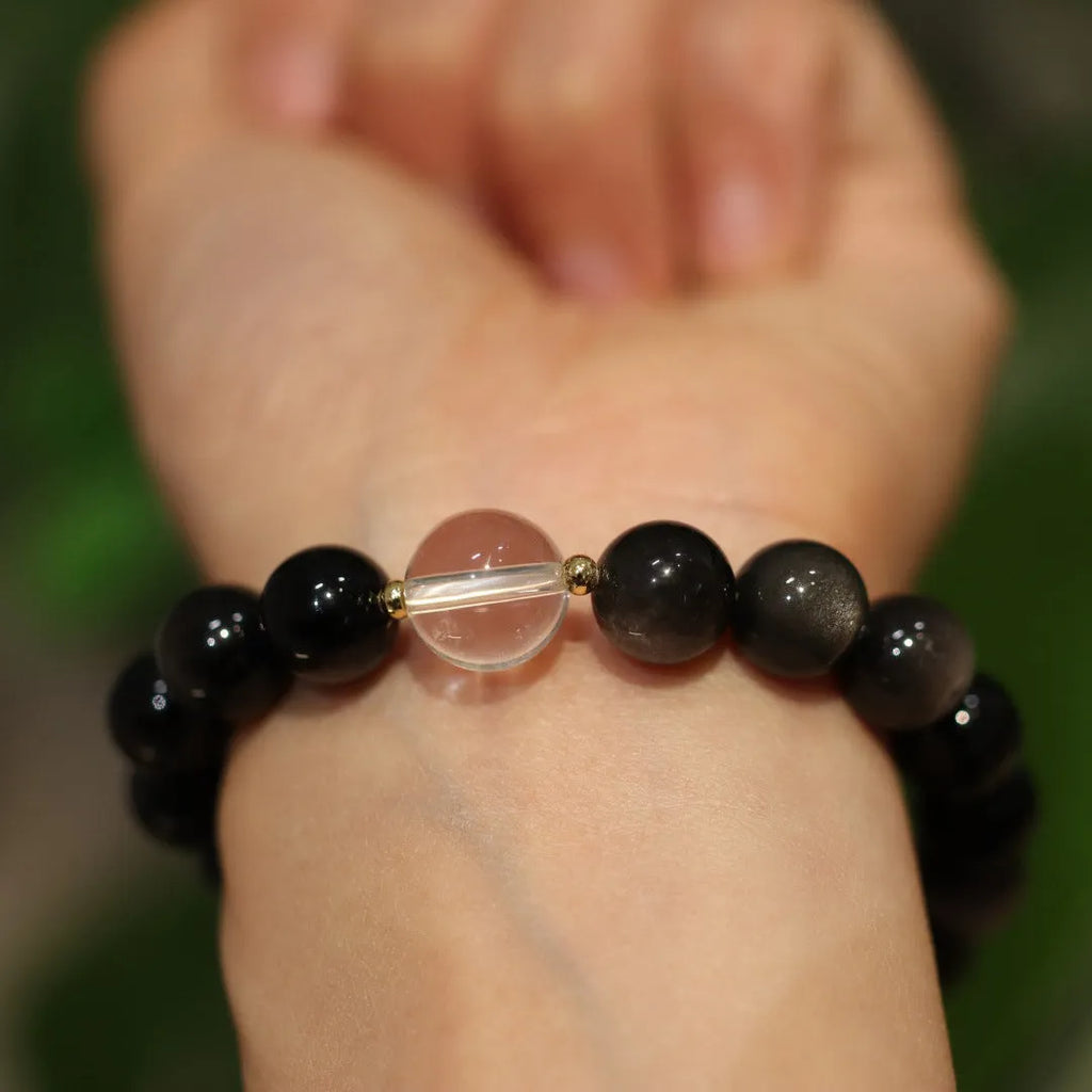 White crystal bracelet with geometric Chinese auspicious patterns and cat eye obsidian detailing
