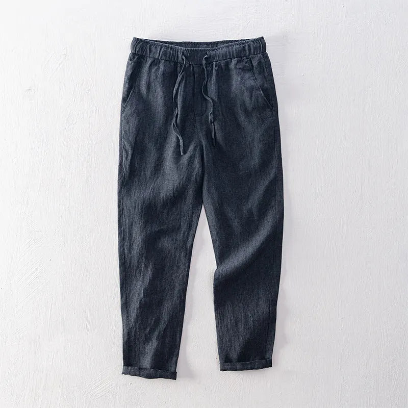 Men's straight-leg linen trousers in light gray shown laid flat.