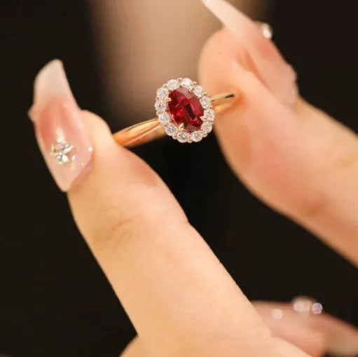 Gold Pigeon silver-plated ring with red blood gemstone and flower pattern, side view on white background