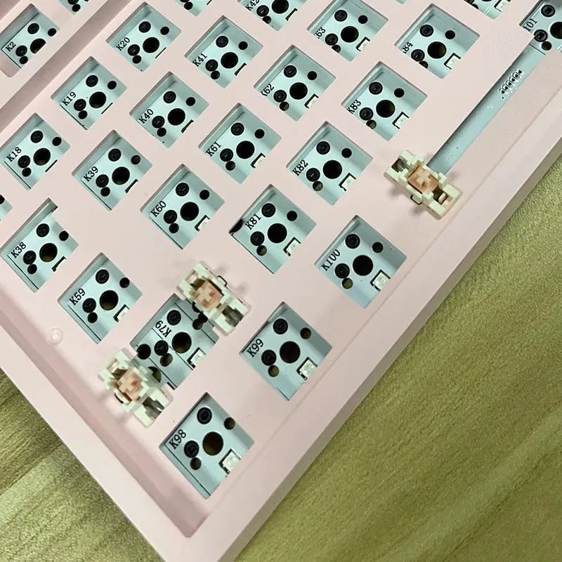 DIY mechanical keyboard kit with transparent case showing internal components and key puller tool