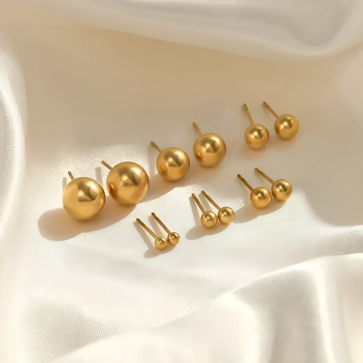 Simple stainless steel stud earrings geometric sphere design available in gold and steel colours multiple sizes