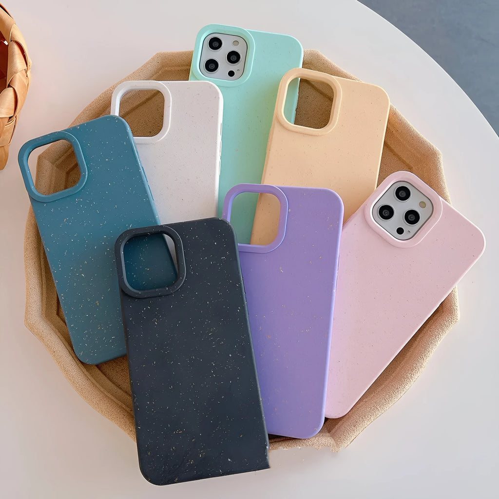 Degradable wheat straw phone case for Apple iPhone on a wooden surface.