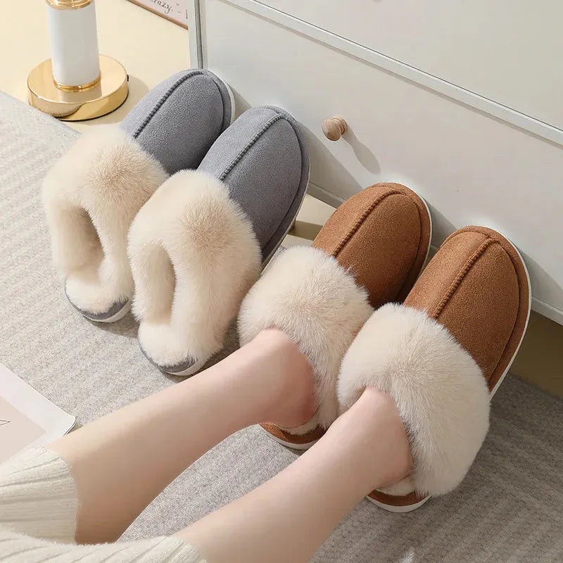 Brown plush indoor slippers with round toe, flat heel, and stitched detail on a PVC sole.
