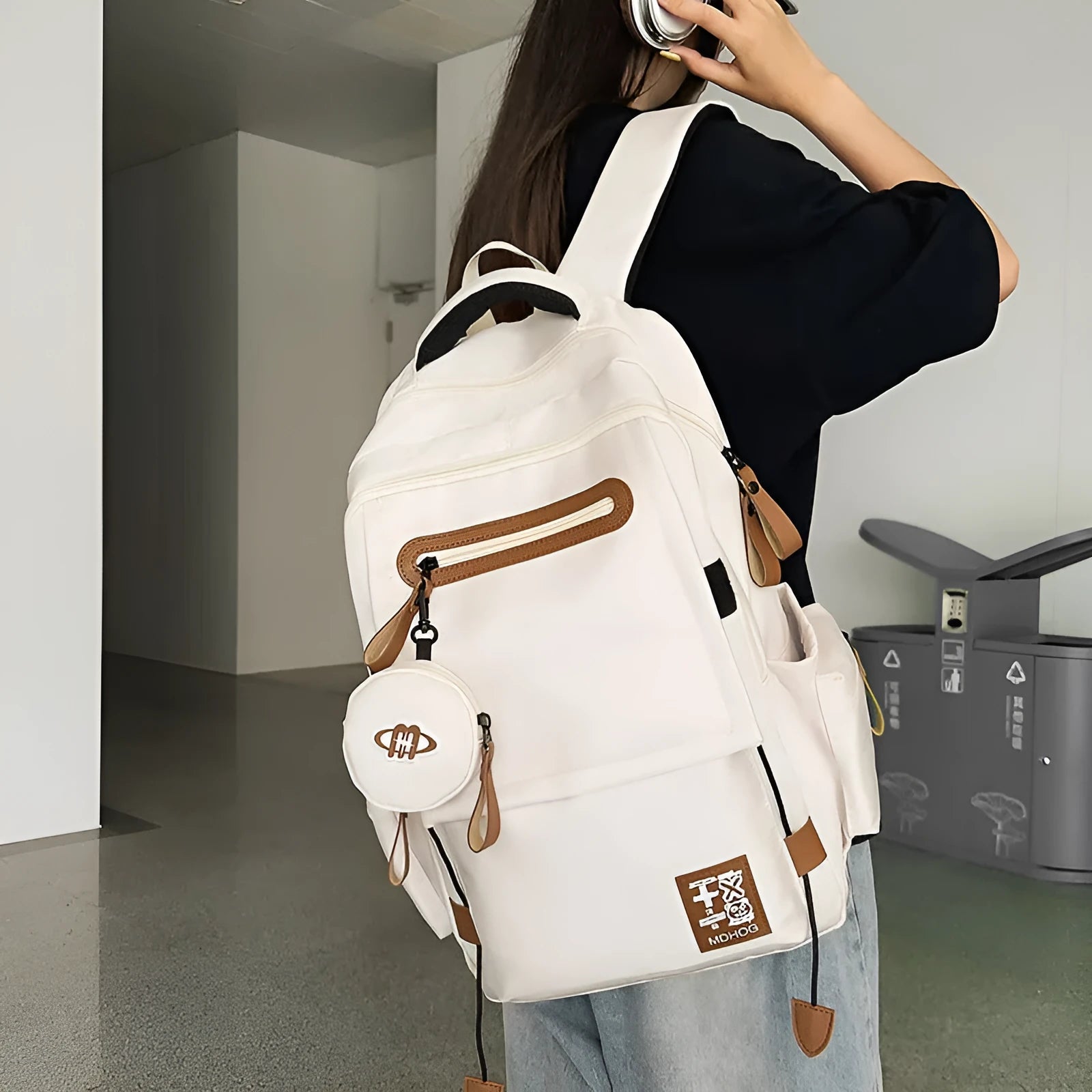 Large black waterproof nylon travel backpack with contrast stitching, shown with a 20-35L capacity.