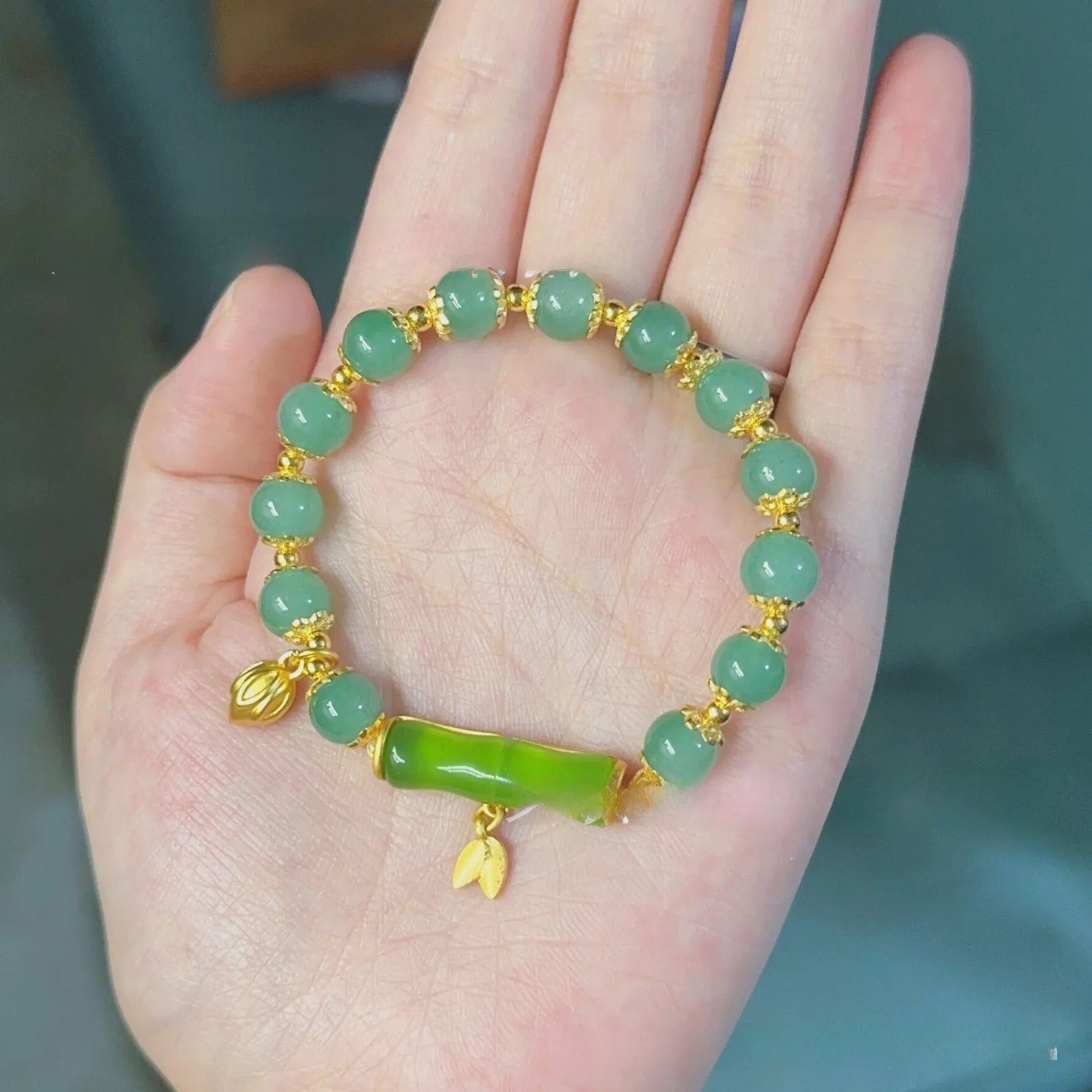 Retro style bamboo bracelet with coloured glass floral beads and ruyi design