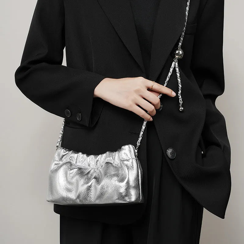 Women's soft cowhide leather crossbody bag in dumpling shape with a single strap.