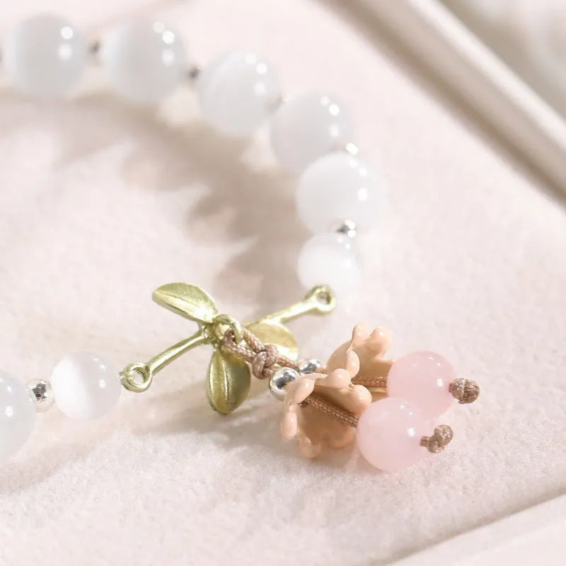 Women's cat's eye stone beaded bracelet with diamond-shaped opal beads and electroplated metal clasp in one of sixteen colour options
