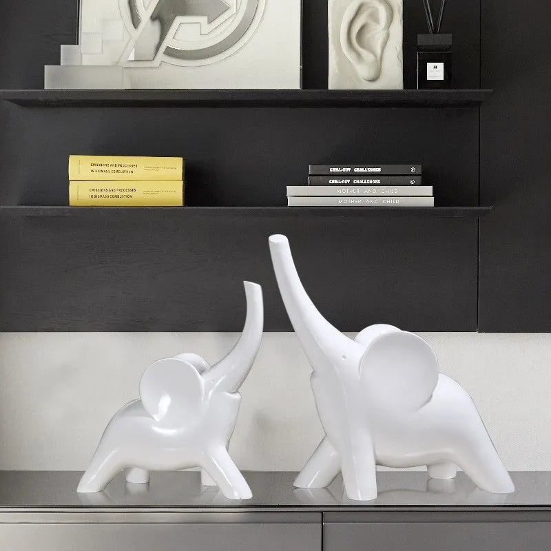 Modern resin elephant ornament in rose gold colour with raised trunk on display surface