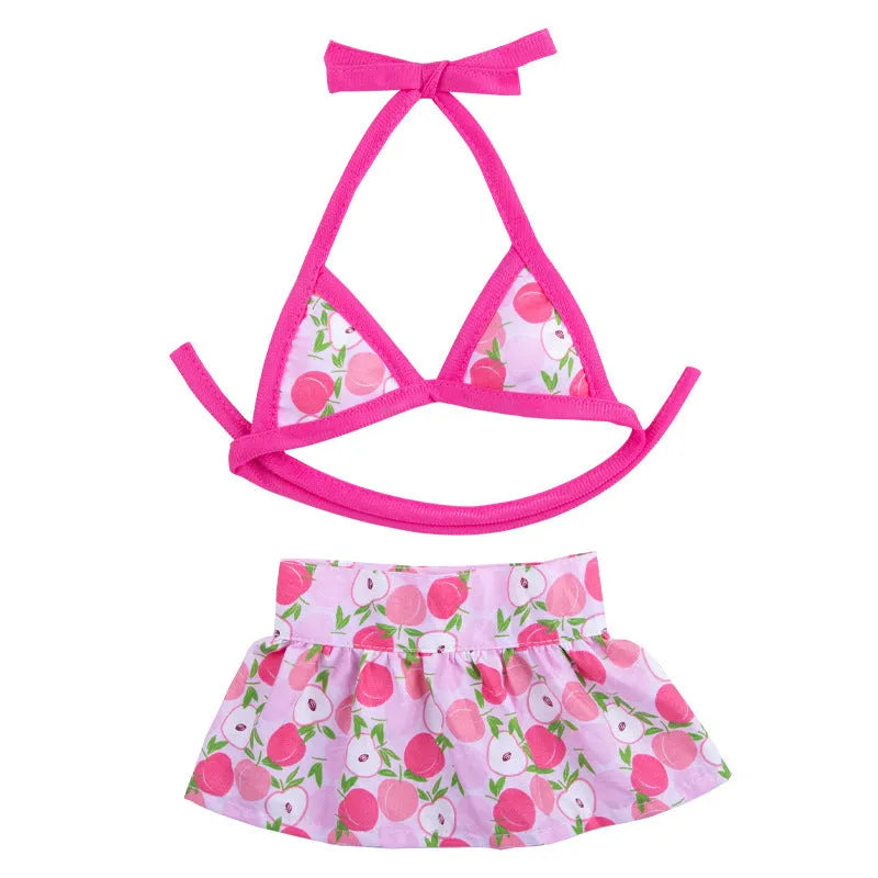 Dog wearing a pink dots polyester bikini suit lying on grass, summer pet clothing