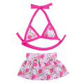Dog wearing a pink dots polyester bikini suit lying on grass, summer pet clothing