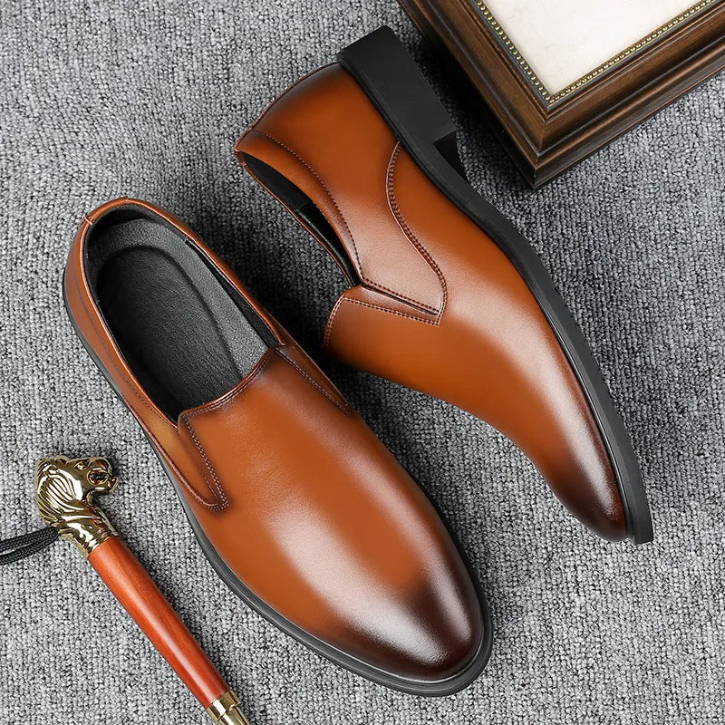 Men's black leather slip-on loafers with a rubber sole and leather toe cap on a white background.