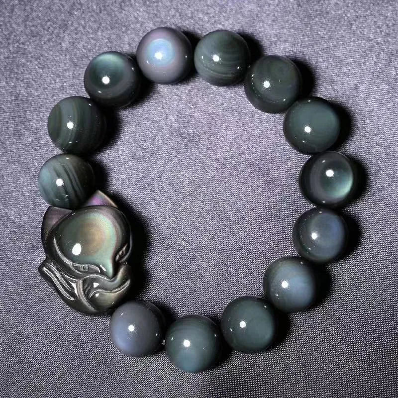 Obsidian stone bracelet with carved fox design in cartoon style, shown in various sizes