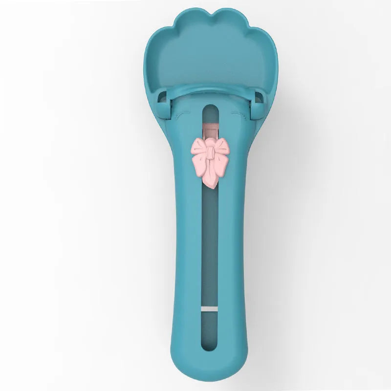 Green and pink pet feed spoon for snack extrusion and cereal dispensing with squeezer feeder design