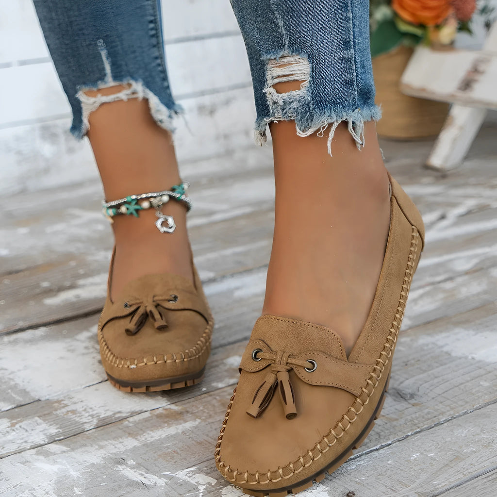 Women's casual flat shoes with bow detail in suede, shown in a solid colour.