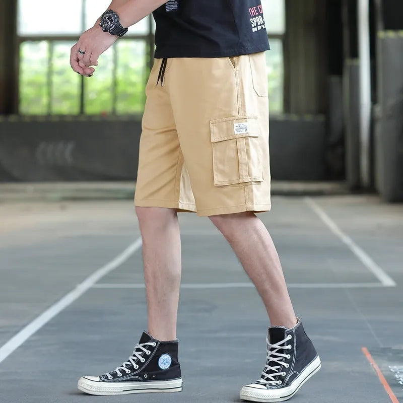 Man wearing loose-fit khaki casual trousers, showing the Korean style and thin fabric texture.