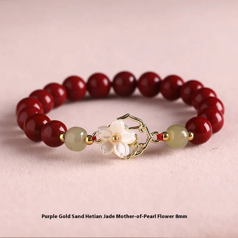 Cinnabar bracelet with Hetian Jade lotus charm and Bells of Ireland accents in New Chinese style