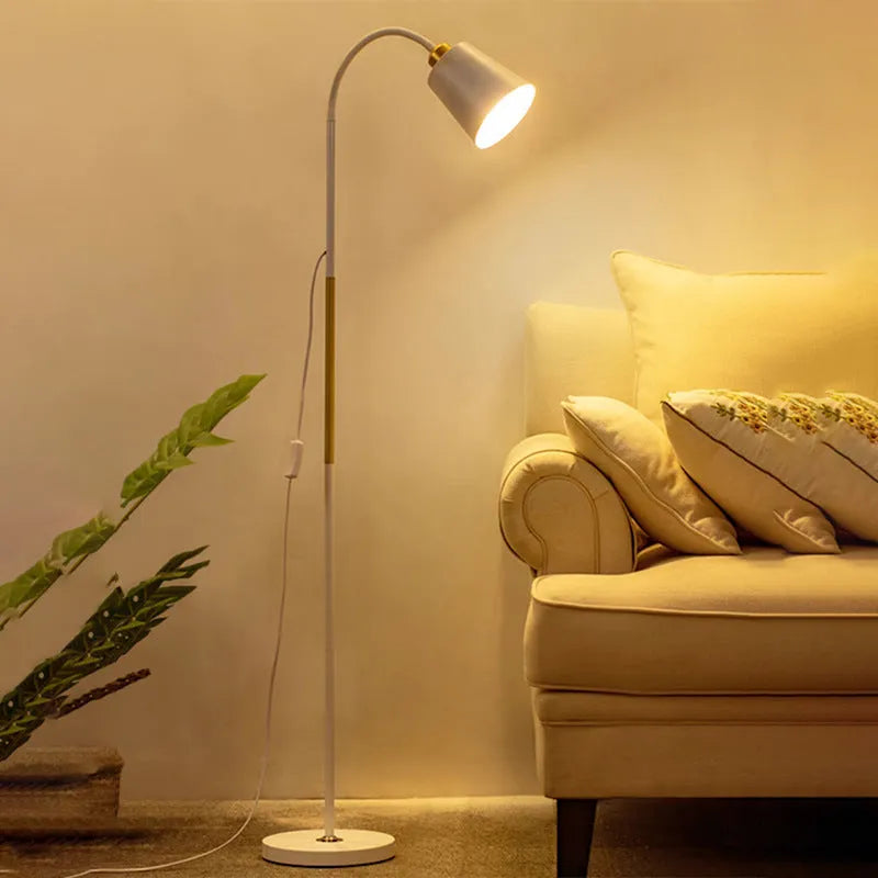 Nordic style black and gold floor lamp with eye-protection LED light next to a sofa.