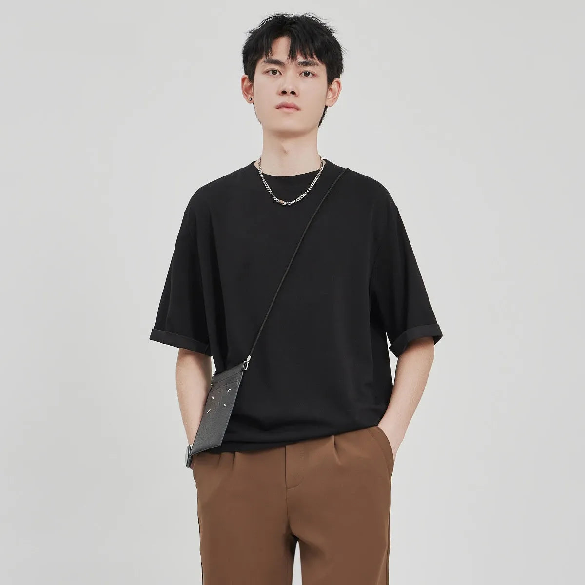 Men's drape knit loose fit t-shirt in polyester blend fabric showing black, brown, and white colour options