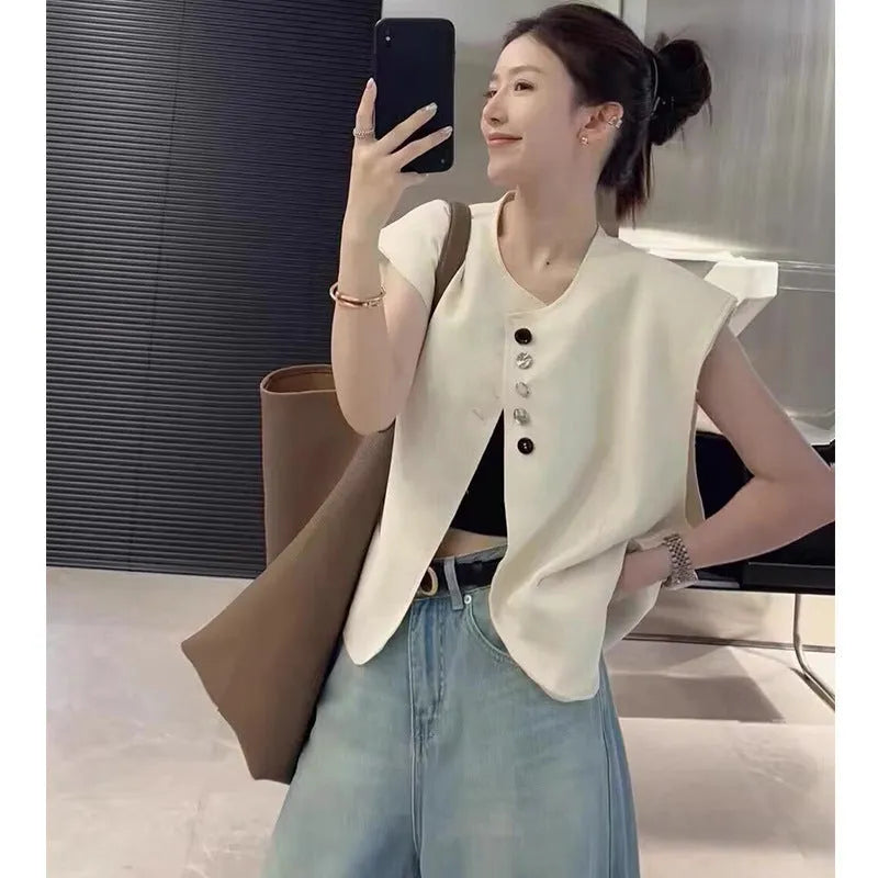 Women's loose fit polyester vest in short length with pockets, shown in milk white colour