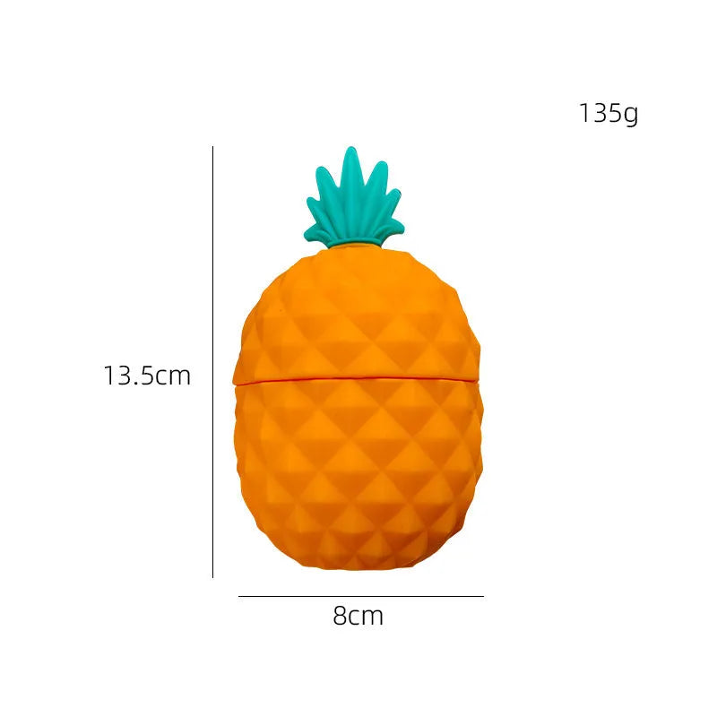Silicone facial ice mold in pineapple style, pink colour, with ice cubes on a white background