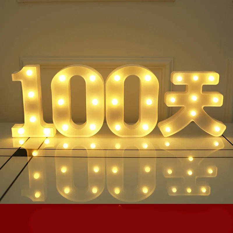 Plastic LED letter light decoration spelling a message, 22cm in height.