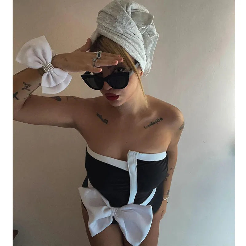 Women's black and white colour-block one-piece swimsuit with irregular tube top and bow detail