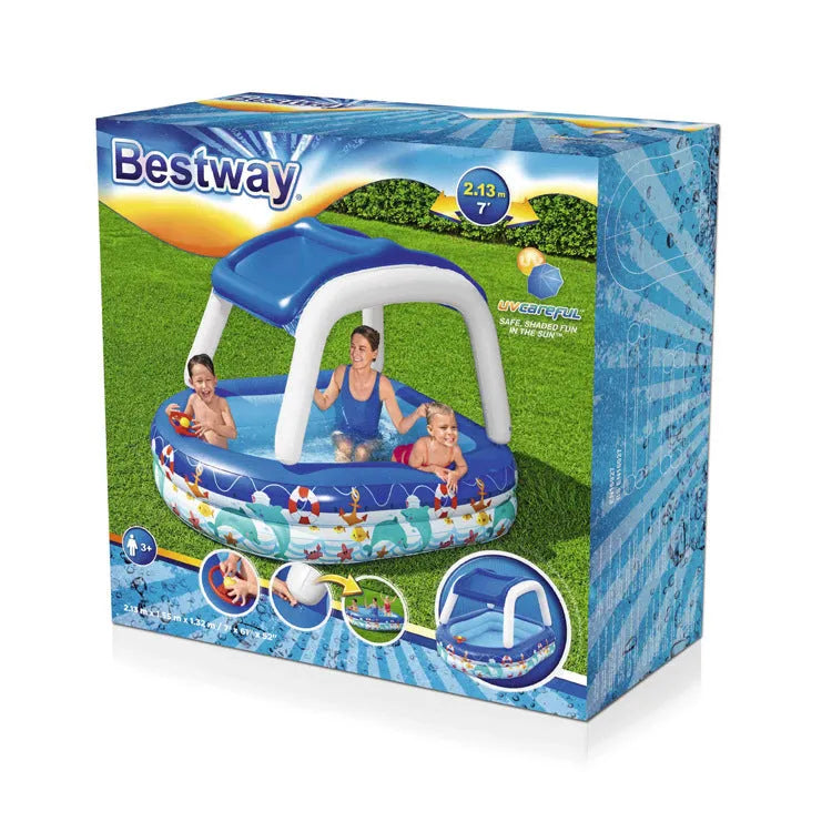Boat type inflatable PVC sunshade paddling pool for children, 2.13m long, blue with yellow canopy, set up in garden
