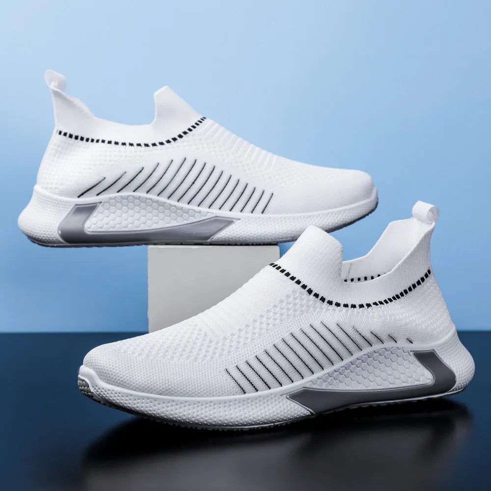 Men's black and white striped slip-on sneakers with lace-up front and mesh design.