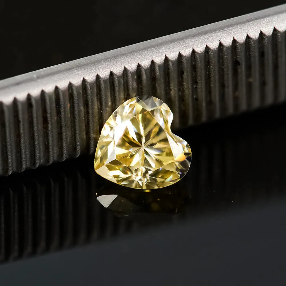 Lemon yellow heart-shaped moissanite gemstone showing symmetrical cut and warm colour