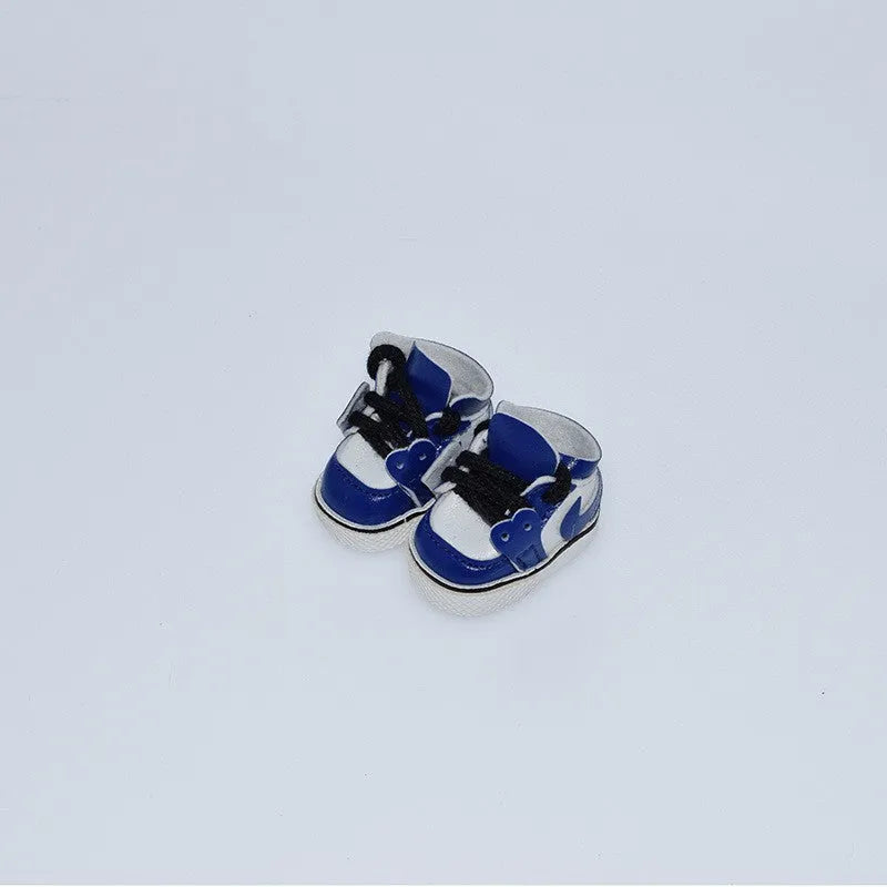 A pair of 17cm scale PU doll shoes in a selected colour and style, such as black leather shoes or brown boots.