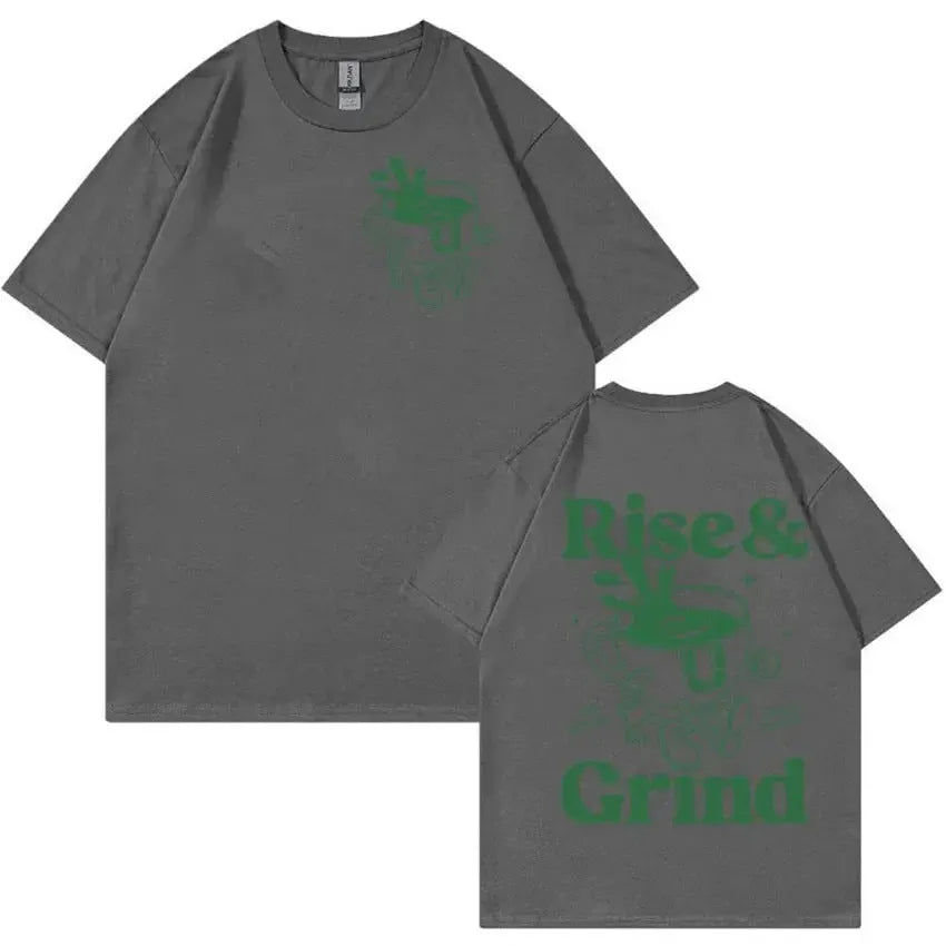 A loose-fit linen T-shirt with a Rise And Grind Green Coffee cartoon print, shown in one of ten available colours.