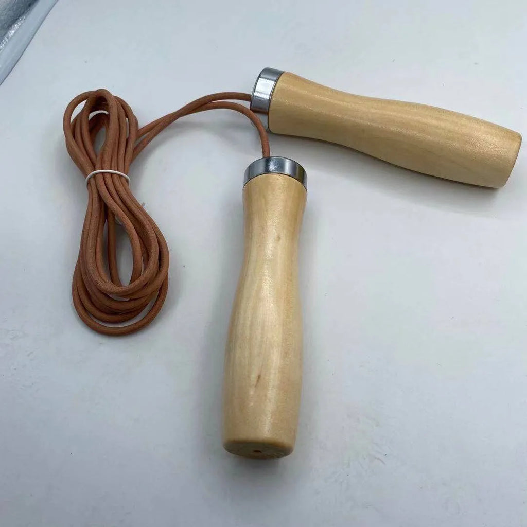 Real cowhide leather jump rope with solid wood handles and denim grip on grey background