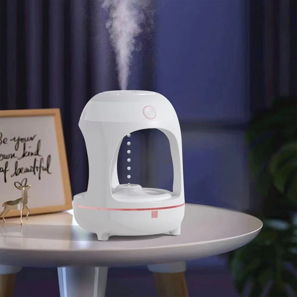 Rose gold and white levitating water drops ultrasonic humidifier and LED night light on a desk