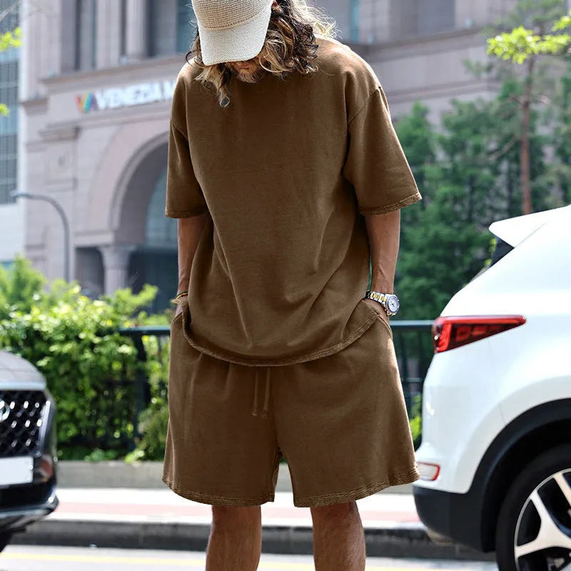 Men's casual sports suit set with grey round neck T-shirt and drawstring shorts on model