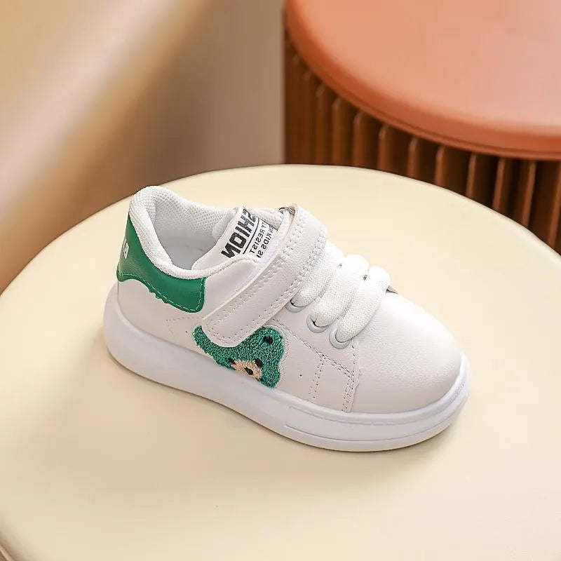 Children's black cartoon bear casual sports shoes with artificial leather upper and rubber sole.