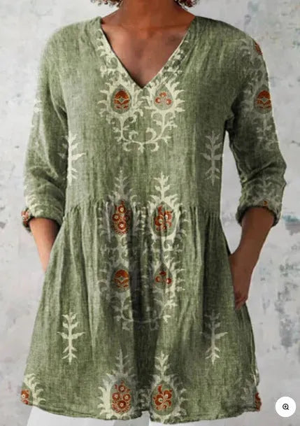 Women's floral wave print dress with wide waist and three-quarter length sleeves on a hanger.