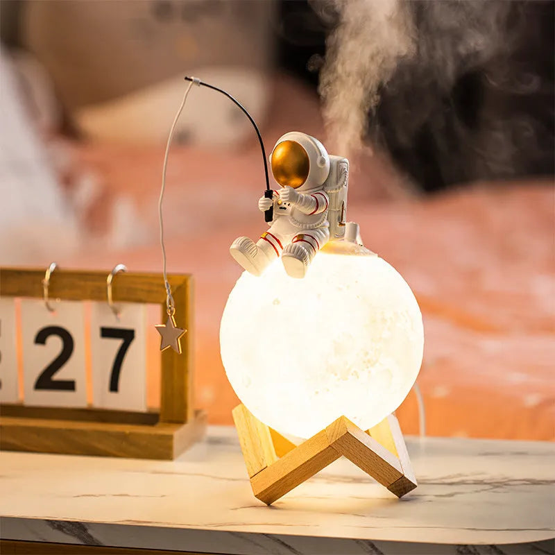 Gold astronaut resin figurine USB humidifier and night light on a wooden base